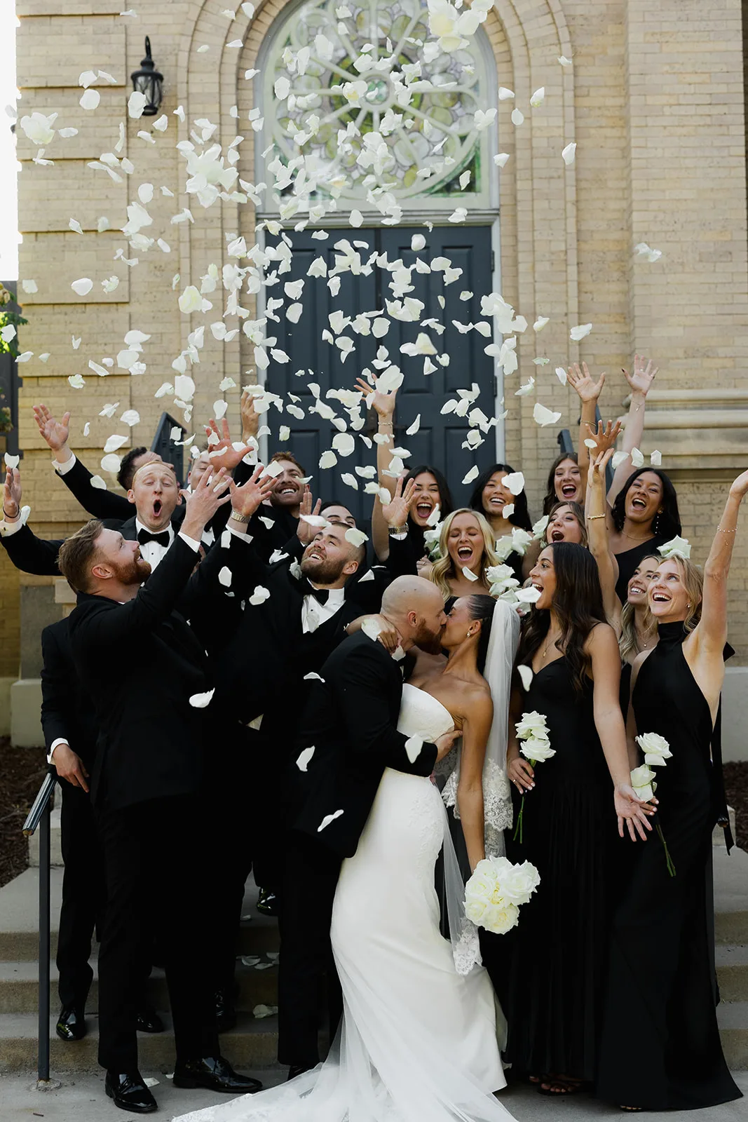 Dip kiss and a petal toss with the wedding party
